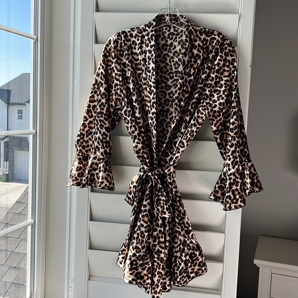 Soft animal print robe with a feminine ruffle on sleeve and bottom.